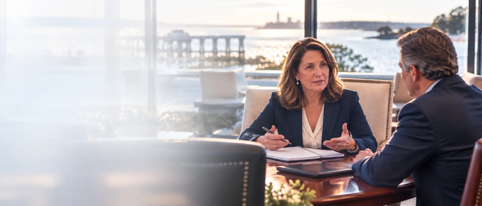 Lauren Drummond Dale, MCBI, meeting with a business owner in a waterfront office